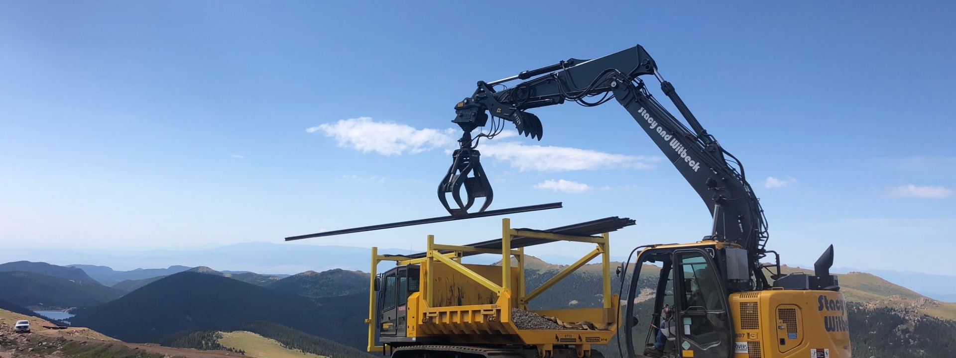 A crane lifting a metal pole on Pikes Peak Mountain