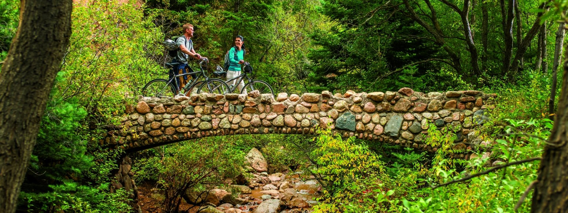 A couple biking over a bridge in Colorado Springs