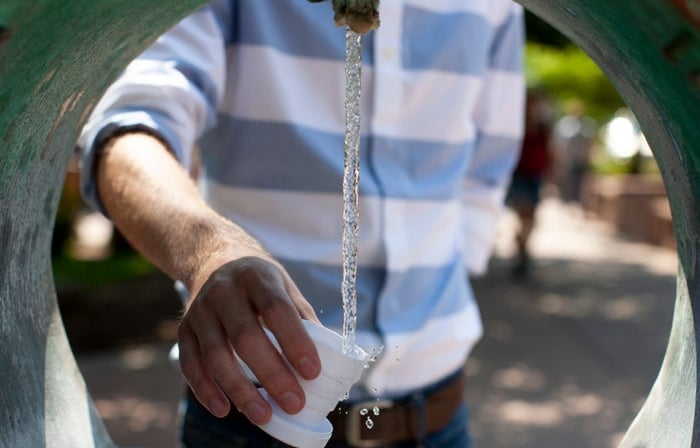 A man getting a drink of the healing waters in Historic Manitou Springs