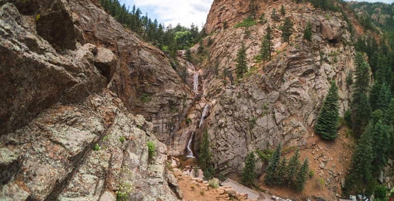 Aerial view of waterfall in canyon on sunny afternoon