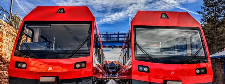 Red trains on tracks closeup from the front