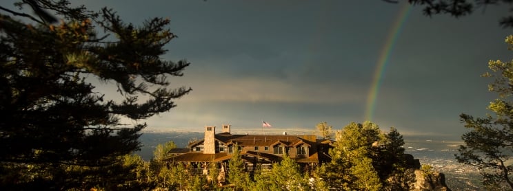Lodge on mountain with rainbow