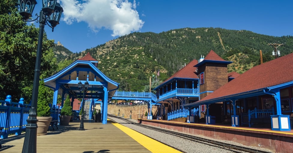 Blue building with red trim on summer day