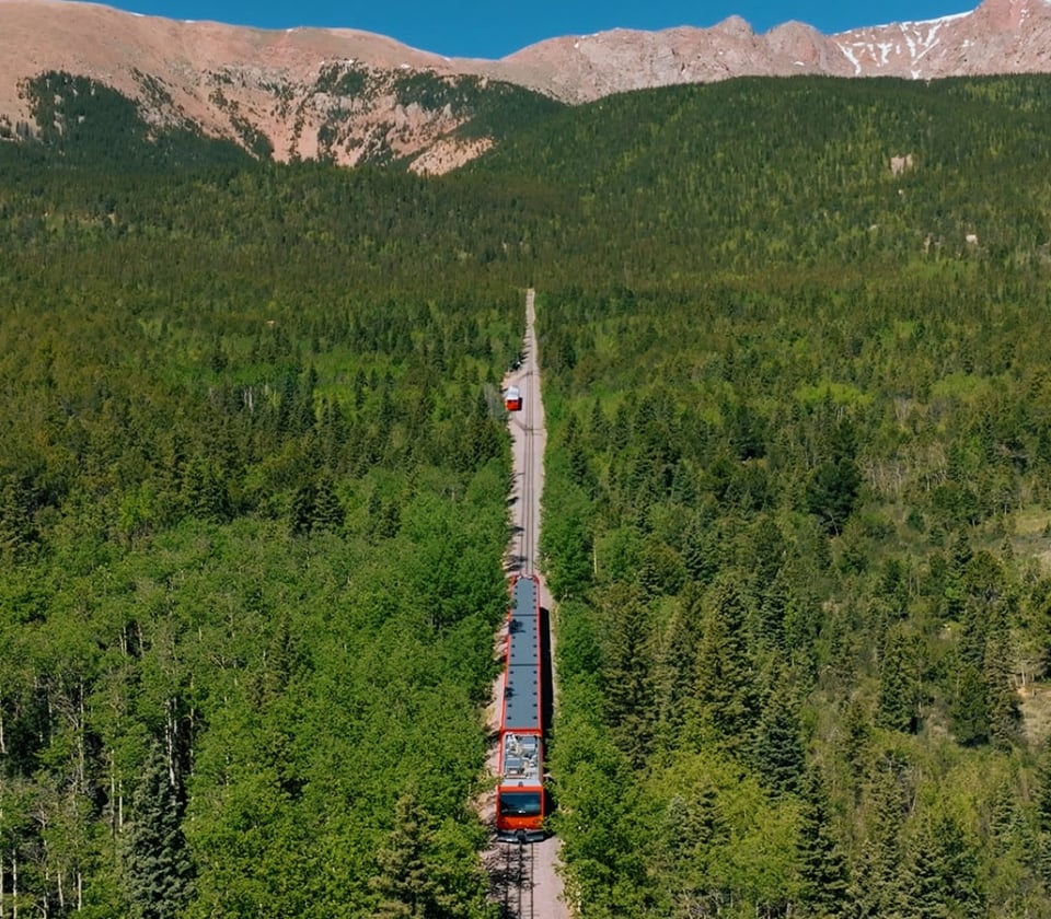 A Red Train In The Middle Of A Forest